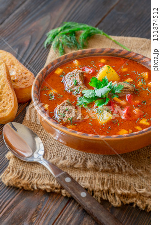Traditional Bogracs stew garnished with parsley served with toasted bread beside Traditional Bogracs stew garnished with parsley served with toasted bread beside 131874512