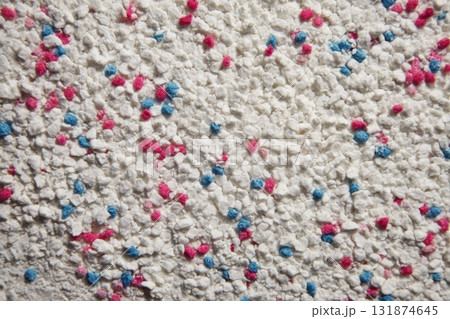 White cat litter round particles surface with small blue colored particles, top view. Granules of pet white-gray litter background. Dog litter texture backdrop with small dots. Flat lay, copy space 131874645