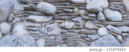 Close-up of rough stone texture. Natural gray stones close-up. Granite stones. 131874933