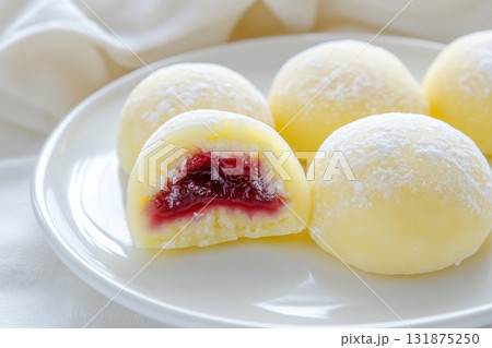 Delicious Japanese moti desserts. Close up. Asian rice daifuku dessert sweet mochi. Cut in half with filling. Traditional dessert mochi ice cream. Colorful rice cake. Fukashi manju. Culinary delights 131875250