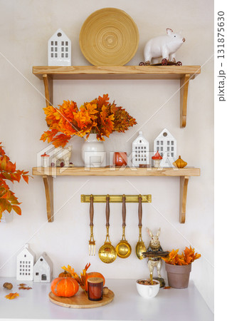 Kitchen autumn decor with pumpkins, kitchen utensils, and vibrant foliage in bright space 131875630