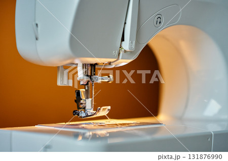 Close-up of sewing machine needle and presser foot 131876990