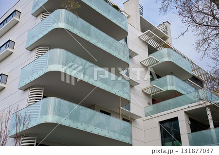 Modern apartment building with glass balconies in city Modern apartment building with glass balconies in city 131877037
