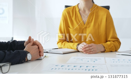 Business professionals discussing financial charts, collaborating on data analysis and strategic planning in contemporary workplace setting with graphs and reports Business professionals discussing financial charts, collaborating on data analysis and strategic planning in contemporary workplace setting with graphs and reports 131877315