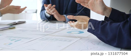 Teamwork and business collaboration with colleagues joining hands over financial charts, symbolizing unity, partnership, success, and strategic corporate planning Teamwork and business collaboration with colleagues joining hands over financial charts, symbolizing unity, partnership, success, and strategic corporate planning 131877504