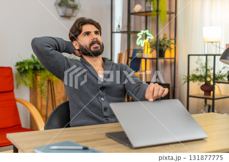 Indian man finalizes report on laptop presses send closes lid smiles relief work done time to rest Indian man finalizes report on laptop presses send closes lid smiles relief work done time to rest 131877775