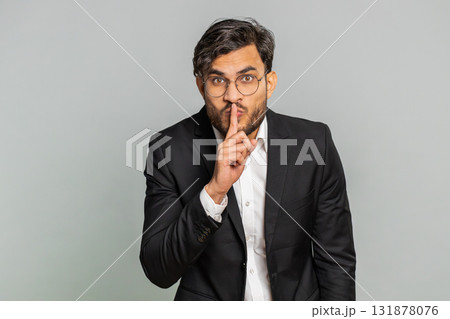 Businessman presses finger to lips make silence gesture sign do not tells secret stop gossip privacy Businessman presses finger to lips make silence gesture sign do not tells secret stop gossip privacy 131878076