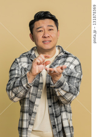 Asian man show a little bit gesture begging help need some more please give me measuring small size 131878369