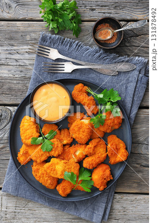 breaded chicken breast chunks with dipping sauce 131878492