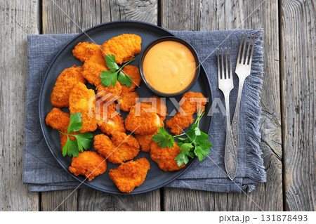 breaded chicken breast chunks with dipping sauce 131878493
