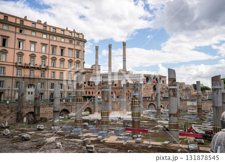 Ancient Roman ruins with stone columns and historical buildings under cloudy sky 131878545
