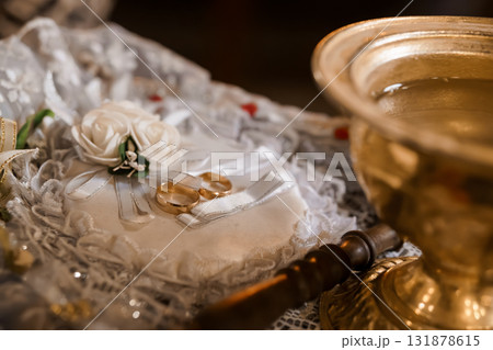 Orthodox Wedding Ceremony Rings and Holy Water on Embroidered Cloth, Golden Tones, Lace Texture, Religious Tradition, Still Life Photography Orthodox Wedding Ceremony Rings and Holy Water on Embroidered Cloth, Golden Tones, Lace Texture, Religious Tradition, Still Life Photography 131878615
