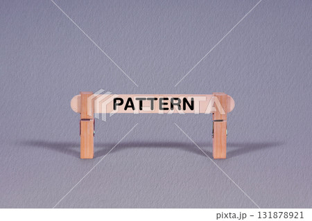 Pattern symbol. Single Wooden stick restrained by Clothespins, beautiful Gray Background. Business and Pattern concept with copy space Pattern symbol. Single Wooden stick restrained by Clothespins, beautiful Gray Background. Business and Pattern concept with copy space 131878921