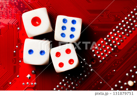 A close-up of the devil's dice lying on an electronic circuit board. The devil's dice are on a microchip. 131879751