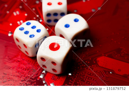 A close-up of the devil's dice lying on an electronic circuit board. The devil's dice are on a microchip. A close-up of the devil's dice lying on an electronic circuit board. The devil's dice are on a microchip. 131879752