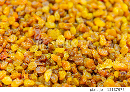 Close up of lots of golden raisins. Dried seedless grapes 131879784