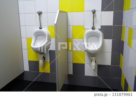 Public toilet with two white urinals 131879981