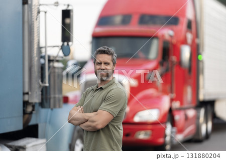 Handsome man driver in front of truck. Trucking owner. Truck driver. Man trucker driver near lorry truck. Transportation vehicles. Semi trucks vehicle. Hispanic man trucker. Logistics service 131880204