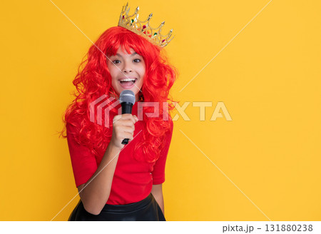positive kid in crown with microphone on yellow background positive kid in crown with microphone on yellow background 131880238