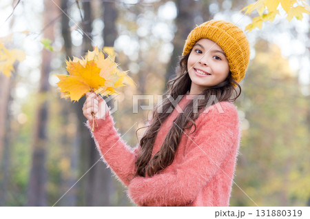 Time to rest. warm clothes fashion. seasonal weather. childhood happiness. beauty of fall nature. happy kid wear sweater and hat. teen girl gathering fallen leaves. child walk in autumn forest Time to rest. warm clothes fashion. seasonal weather. childhood happiness. beauty of fall nature. happy kid wear sweater and hat. teen girl gathering fallen leaves. child walk in autumn forest 131880319
