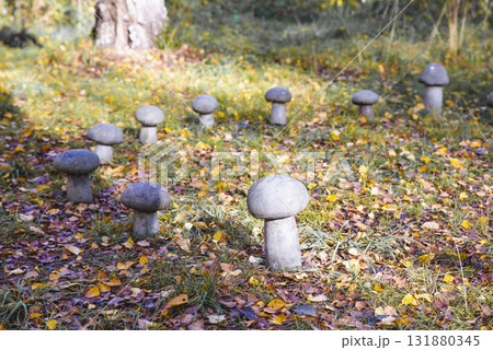 Charming mushroom sculpture nestled amongst ferns and moss in a Cornish woodland scene. A touch of fantasy and nature's magic. Charming mushroom sculpture nestled amongst ferns and moss in a Cornish woodland scene. A touch of fantasy and nature's magic. 131880345