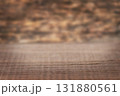 Rustic wooden table on warm brown surface with blurred background for home and cafe scenes 131880561