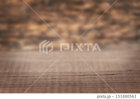 Rustic wooden table on warm brown surface with blurred background for home and cafe scenes Rustic wooden table on warm brown surface with blurred background for home and cafe scenes 131880561