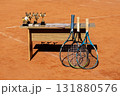 Tennis trophies and rackets on a clay court with a trophy table display 131880576