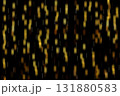 Golden Bokeh Lights Falling Like Sparkling Streaks Across a Dark Night Background 131880583