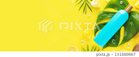 Cosmetic banner with blue cosmetic bottle with slices of citrus fruits, ice cubes and exotic leaves on yellow background with copy space. Moisturizing, summer beauty product with natural ingredients Cosmetic banner with blue cosmetic bottle with slices of citrus fruits, ice cubes and exotic leaves on yellow background with copy space. Moisturizing, summer beauty product with natural ingredients 131880667