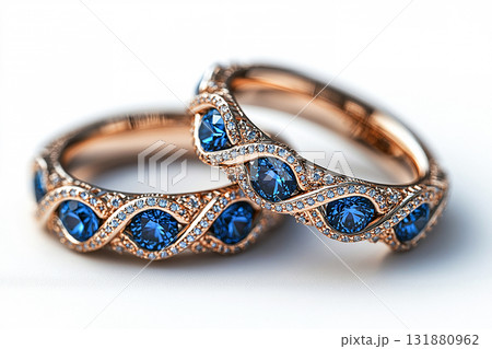Luxurious pair of wedding rings with blue stones on a white background. Rococo-Renaissance style. Luxurious pair of wedding rings with blue stones on a white background. Rococo-Renaissance style. 131880962
