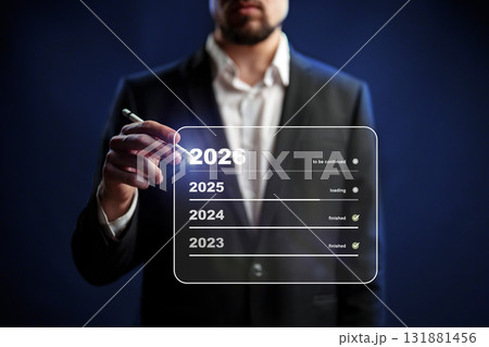 Future planning visualized by a man writing on a digital screen in a dark setting Future planning visualized by a man writing on a digital screen in a dark setting 131881456