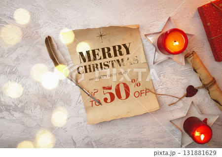 Christmas sale announcement with candlelight and decorative elements on a table Christmas sale announcement with candlelight and decorative elements on a table 131881629