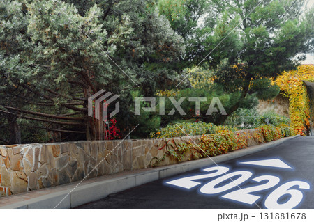 Pathway marked with the year 2026 amidst greenery in a tranquil setting Pathway marked with the year 2026 amidst greenery in a tranquil setting 131881678