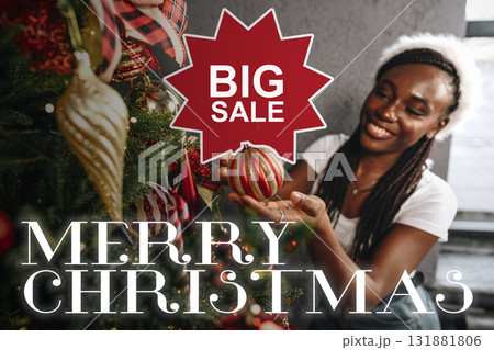 Woman enjoying holiday shopping while sitting on the floor surrounded by Christmas decorations Woman enjoying holiday shopping while sitting on the floor surrounded by Christmas decorations 131881806