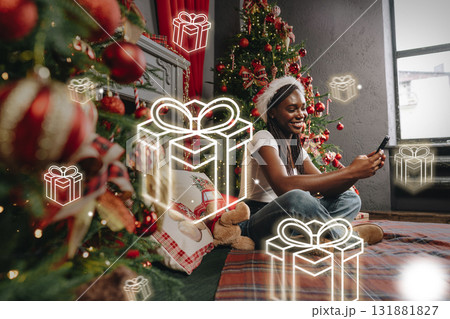 Enjoying the holiday spirit with gifts and decorations in a cozy living room Enjoying the holiday spirit with gifts and decorations in a cozy living room 131881827