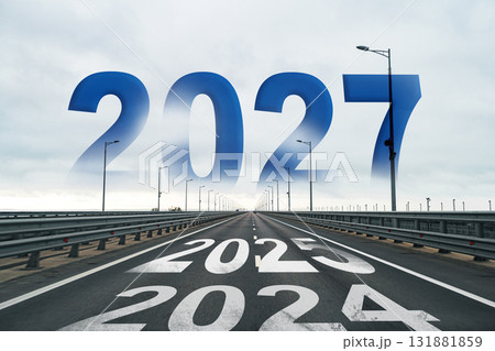 Road leading into the future marked by years 2025 to 2027 on a cloudy day Road leading into the future marked by years 2025 to 2027 on a cloudy day 131881859
