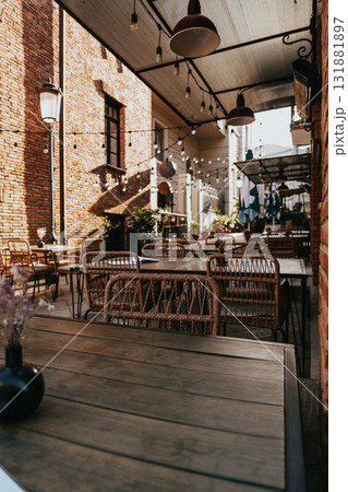 Cozy outdoor dining area with rustic decor and warm atmosphere in the late afternoon 131881897