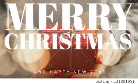 Celebrating Christmas with a festive gift in hand during the holiday season Celebrating Christmas with a festive gift in hand during the holiday season 131881951