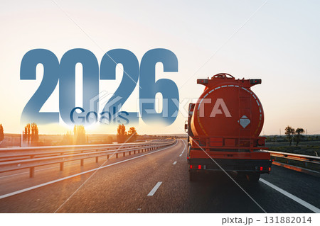 Truck driving towards 2026 goals on a sunny highway with clear skies 131882014