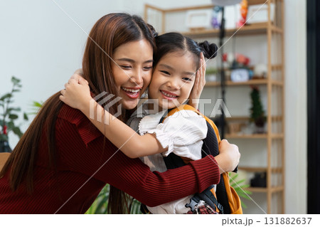 Emotional Bonding Before School. A girl and a woman share a heartfelt hug filled with joy and encouragement. Emotional Bonding Before School. A girl and a woman share a heartfelt hug filled with joy and encouragement. 131882637