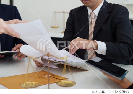 Document Review and Legal Strategy. Lawyers reviewing important documents during a strategic discussion. 131882667