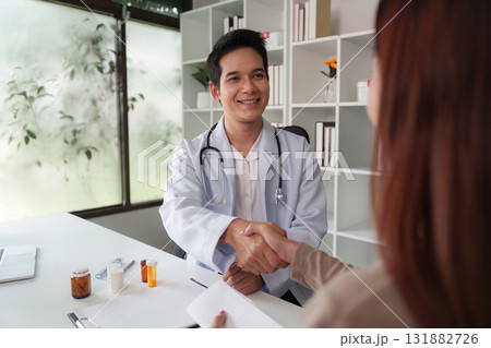 Doctor and Patient Consultation. A doctor providing attentive care during a consultation, ensuring patient engagement in a friendly environment. 131882726