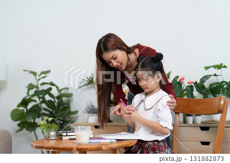 Back to School Preparation and Learning. A mother enthusiastically guides her daughter in getting ready for school. 131882873