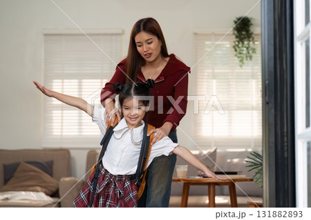 Confidence and Adventure. A mother encourages her daughter to embrace her school journey with imagination. Confidence and Adventure. A mother encourages her daughter to embrace her school journey with imagination. 131882893