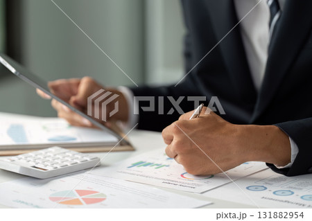 Business Analysis and Reporting. A professional analyzes business data, emphasizing the importance of accurate reporting for decision-making. 131882954
