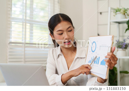 Presentation and Communication. A young professional presenting data insights using visual charts during an online meeting. 131883150