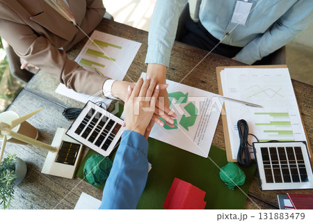 Collaboration and Sustainability. Business professionals engaging in a sustainable project discussion, fostering eco-friendly initiatives. Collaboration and Sustainability. Business professionals engaging in a sustainable project discussion, fostering eco-friendly initiatives. 131883479