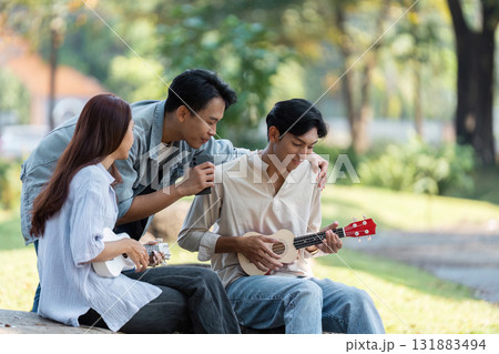 Friends bonding over music and snacks in the park Friends bonding over music and snacks in the park 131883494