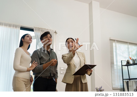 Real estate agent presenting property details to clients, highlighting features and benefits. Real estate agent presenting property details to clients, highlighting features and benefits. 131883513
